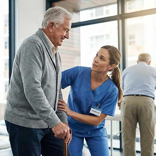 Dedicated team member assisting a patient with genuine care and empathy.