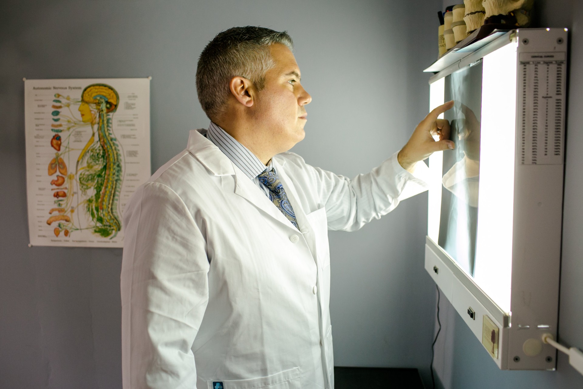 Doctor reviewing X-ray results with a patient to explain the structural source of pain.